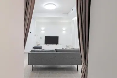 a bedroom with a bed and a tv in a room at Buddha Luxury Apartment Kaunas city centre in Kaunas