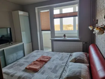 a bedroom with a bed with two towels on it at Pas Romaną in Zarasai
