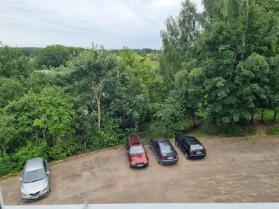 a group of cars parked in a parking lot at Pas Romaną in Zarasai