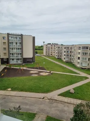 an empty park in a city with apartment buildings at Pas Romaną in Zarasai