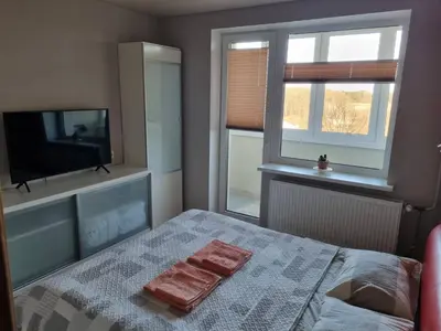 a bedroom with a bed with two towels on it at Pas Romaną in Zarasai