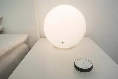 a white table with a clock on top of it at Laurentroom Central Park in Ukmergė