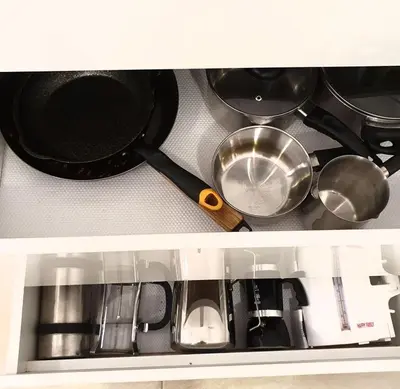 a kitchen counter with pots and pans on a stove at Home sweet home in Radviliškis