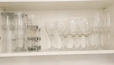 a row of wine glasses sitting on a shelf at Home sweet home in Radviliškis