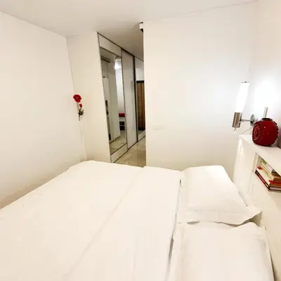 a white bed in a room with a mirror at Home sweet home in Radviliškis