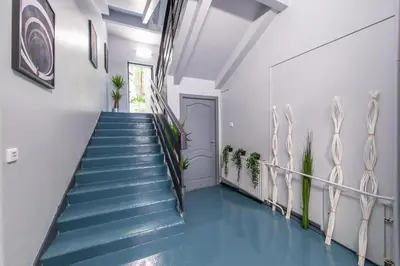 a hallway with blue floors and stairs with a blue floor at The house black in Vilnius