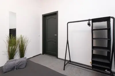 a room with a door and a tripod next to a door at The house black in Vilnius