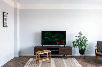 a living room with a tv on a white wall at Old-New Apartment in Central Kaunas in Kaunas