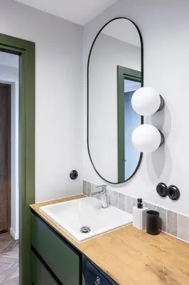 a bathroom with a sink and a mirror at Old-New Apartment in Central Kaunas in Kaunas