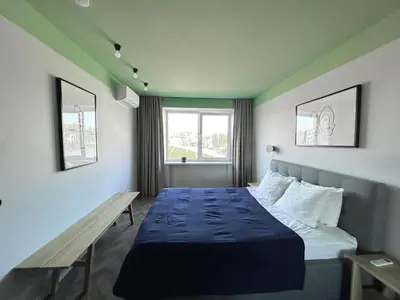 a bedroom with a bed and a bench in it at Old-New Apartment in Central Kaunas in Kaunas