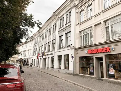a street lined with white buildings with a store at Old Town home of Evil Dog in Vilnius