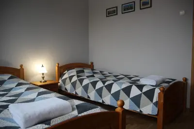 two beds sitting next to each other in a room at Alma B&B in Kalvarija