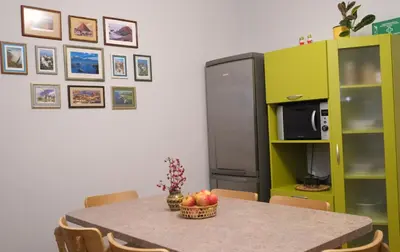 a kitchen with a table with a bowl of fruit on it at Alma B&B in Kalvarija