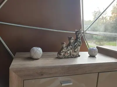 a table with figurines of cats and balls on it at kupolas in Šiauliai