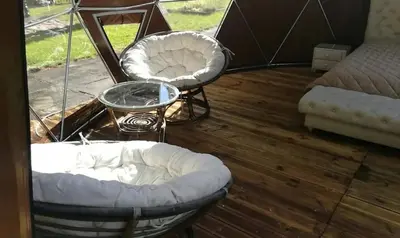 a room with two chairs and a table and a tent at kupolas in Šiauliai