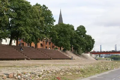 an empty amphitheater with a church and a steeple at Old Town Apartment with a separate entrance in Kaunas