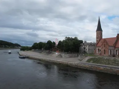 a river with a building and a church and a church at Old Town Apartment with a separate entrance in Kaunas
