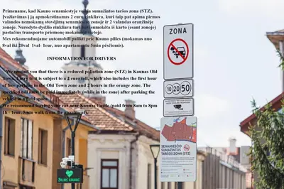 a group of signs on a street with buildings at Old Town Apartment with a separate entrance in Kaunas