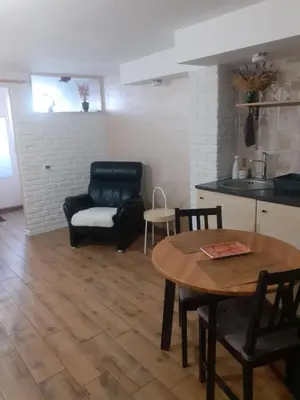 a living room with a table and a chair at Old Town Apartment with a separate entrance in Kaunas