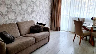 a living room with a couch and a table at Apartment next to Cathedral of Saints Peter & Paul in Šiauliai