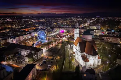 an aerial view of a city at night at Apartment next to Cathedral of Saints Peter & Paul in Šiauliai
