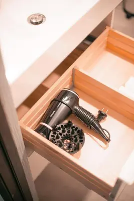 a hair dryer in a wooden box in a drawer at Laurentroom Center in Ukmergė
