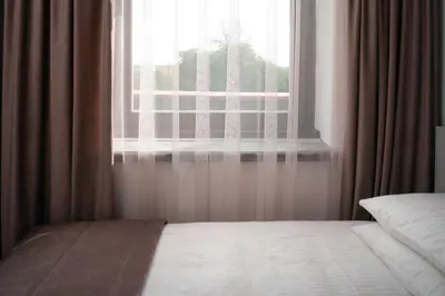 a bedroom with a bed and a window at Laurentroom Center in Ukmergė