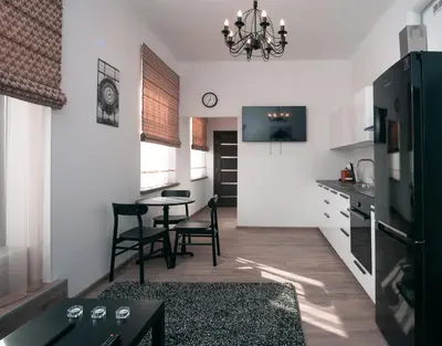 a kitchen with a table and chairs in a room at Laurentroom Center in Ukmergė