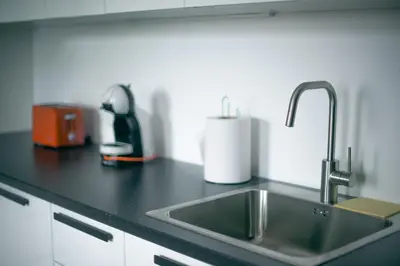 a kitchen counter with a sink and a appliance at Laurentroom Center in Ukmergė