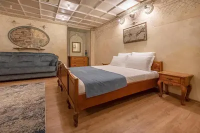 a bedroom with a bed and a couch at Beautiful one bedroom apartment in Vilnius old town in Vilnius