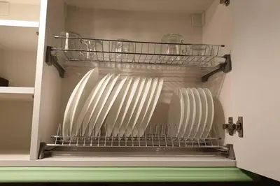 a shelf with three white servers in a closet at Beautiful one bedroom apartment in Vilnius old town in Vilnius