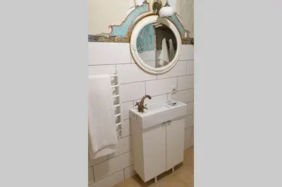 a bathroom with a sink and a mirror at Beautiful one bedroom apartment in Vilnius old town in Vilnius