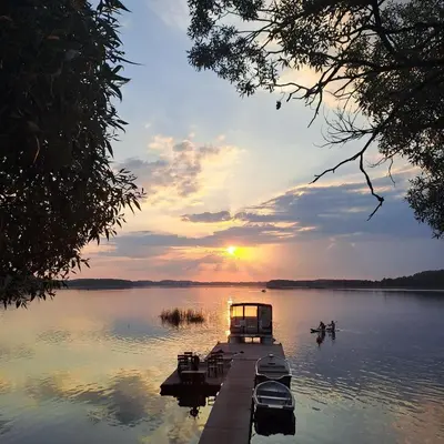 a group of boats on a dock on a lake at Žvejo krantas Palūšė in Palūšė