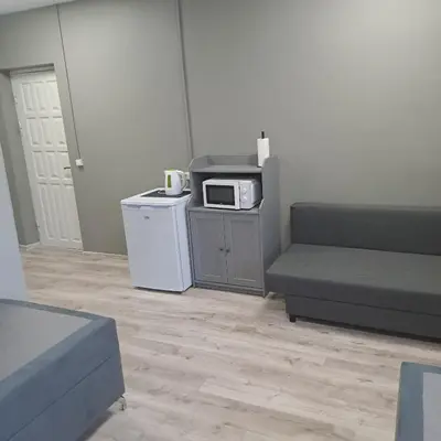 a living room with a couch and a microwave at Žvejo krantas Palūšė in Palūšė