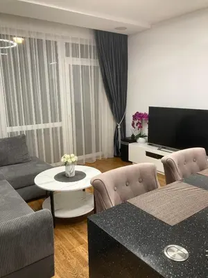 a living room with a couch and a table at Editos Apartamentai in Vilnius
