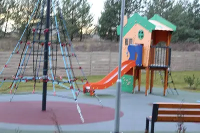 a playground with a slide in a park at Editos Apartamentai in Vilnius