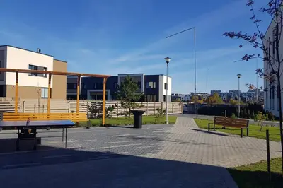 a park with benches and buildings in a city at Editos Apartamentai in Vilnius