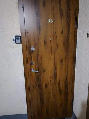 a wooden door with the number on it at Monica Apartments in Panevėžys