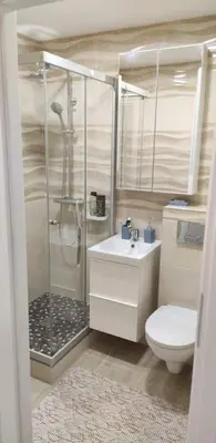 a bathroom with a shower and a sink and a toilet at Butas miesto centre/ Apartment in the city center in Šiauliai
