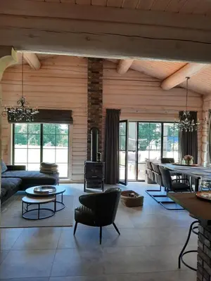 a living room with a couch and a table at Vila Saulė in Sudeikiai