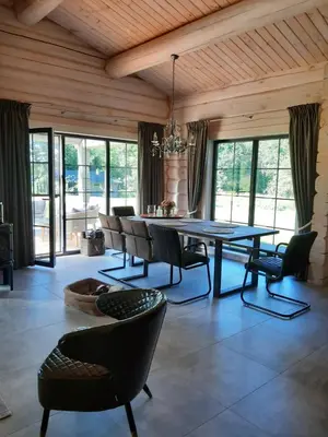 a dining room with a table and chairs at Vila Saulė in Sudeikiai