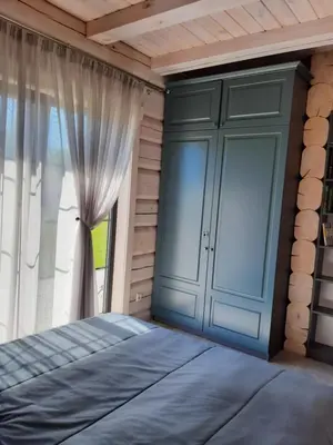 a bedroom with a bed and a window at Vila Saulė in Sudeikiai