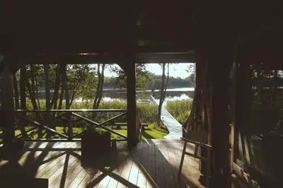 a view from the inside of a house with a porch at Mėnulės pirtelė in Sudeikiai