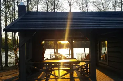 a cabin with the sun shining through the window at Mėnulės pirtelė in Sudeikiai