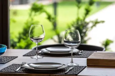 a table with two wine glasses on top of it at Don Vyto in Druskininkai