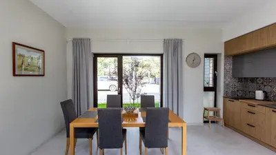 a kitchen and dining room with a wooden table and chairs at Don Vyto in Druskininkai