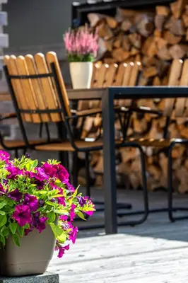 a table and chairs with flowers on a patio at Don Vyto in Druskininkai