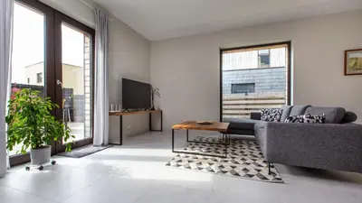 a living room with a couch and a tv at Don Vyto in Druskininkai