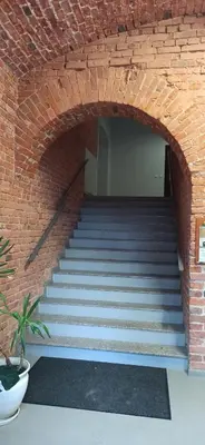 a brick staircase with a brick wall at Studio flat in a historical XIX c. building. in Kaunas