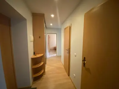 a hallway leading to a room with a door at Butas Senamiestyje in Druskininkai